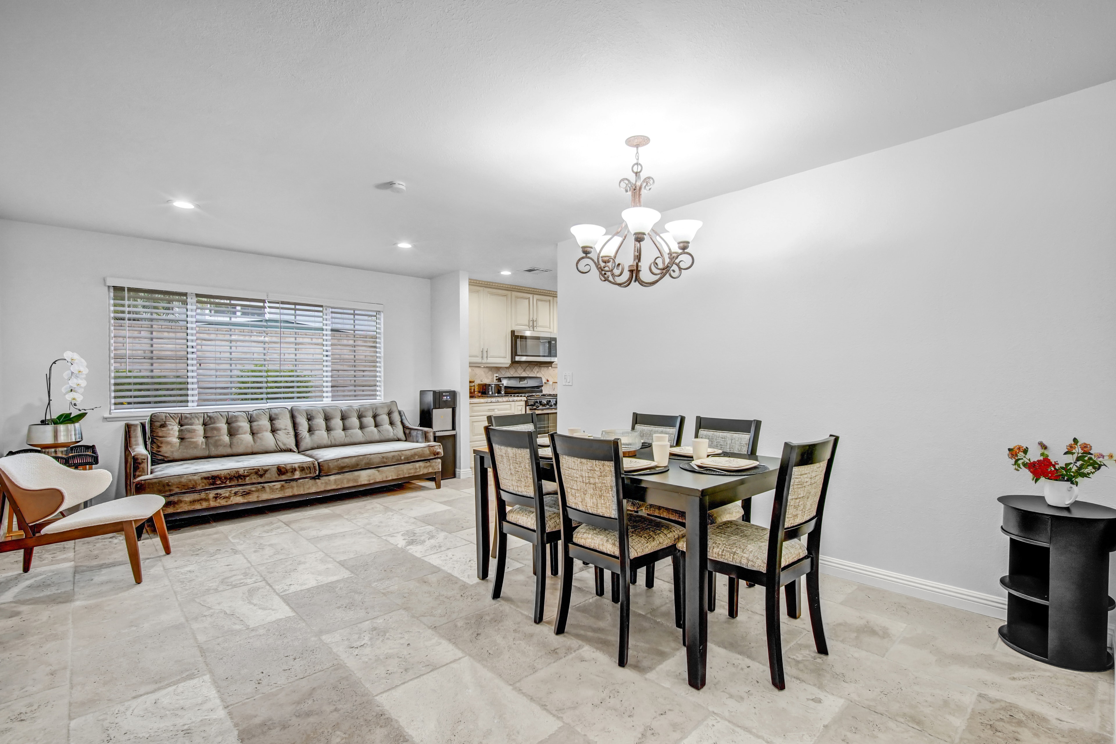Open dining and living area with chandelier